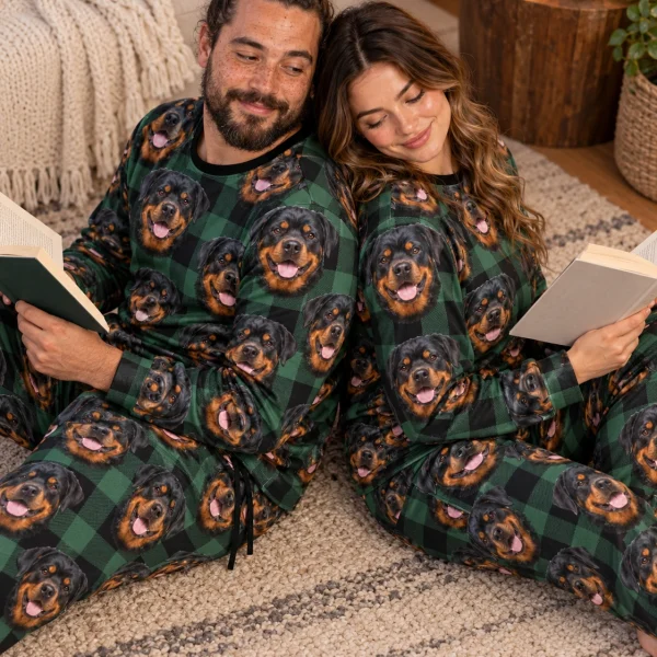 Man and his partner in matching rottweiler pajama set with black-and-mahogany Rottweiler faces — MyDogPics