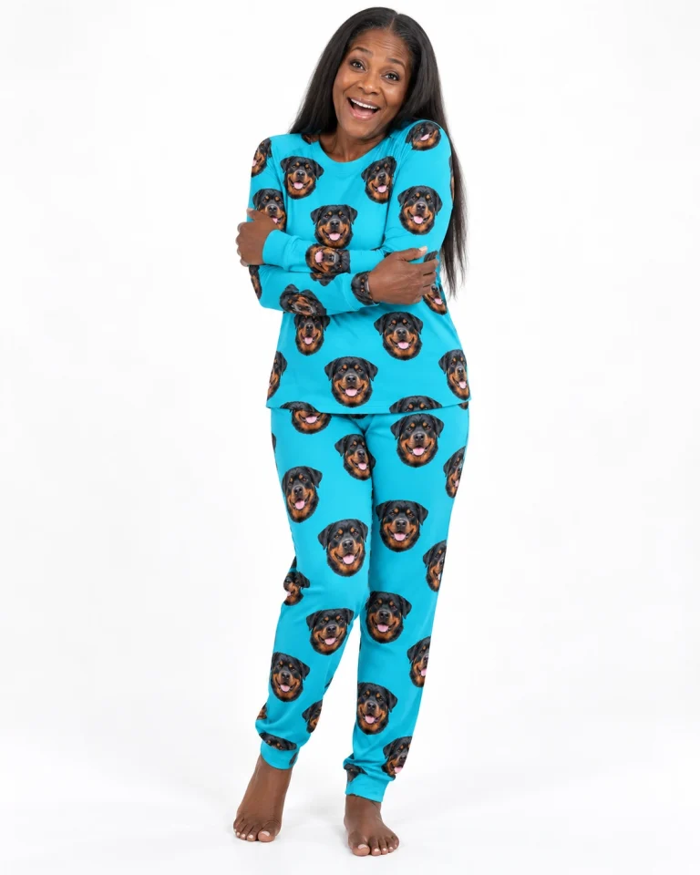 Woman wearing a rottweiler pajamas for adults covered in black-and-mahogany Rottweiler faces on teal fabric — MyDogPics