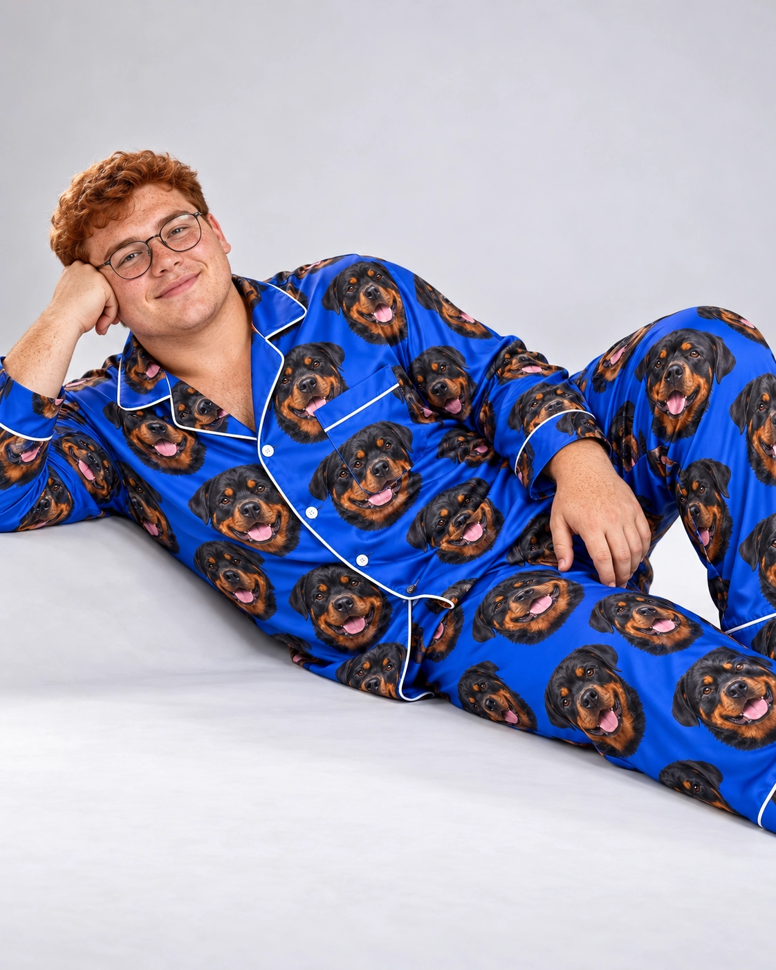 Rottweiler Pajamas for Men – Pose, Royal Blue | MyDogPics Man posing in a rottweiler pajamas for men, black-and-mahogany Rottweiler faces on royal blue satin — MyDogPics