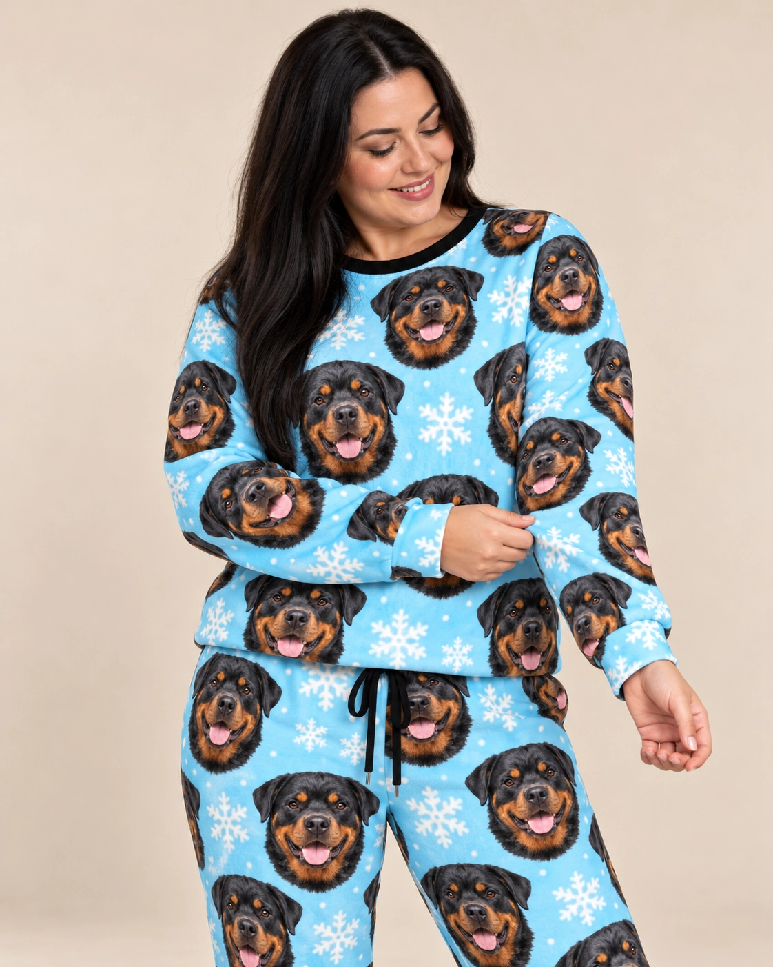 Rottweiler Winter Pajamas – Front View, Light Blue Snowflake | MyDogPics Woman wearing rottweiler winter pajamas covered in black-and-mahogany Rottweiler faces — MyDogPics