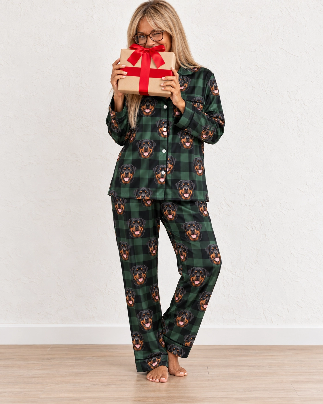 Women’s Rottweiler Christmas Pajamas – Front View, Green Plaid | MyDogPics Woman wearing womens rottweiler Christmas pajamas covered in black-and-mahogany Rottweiler faces — MyDogPics