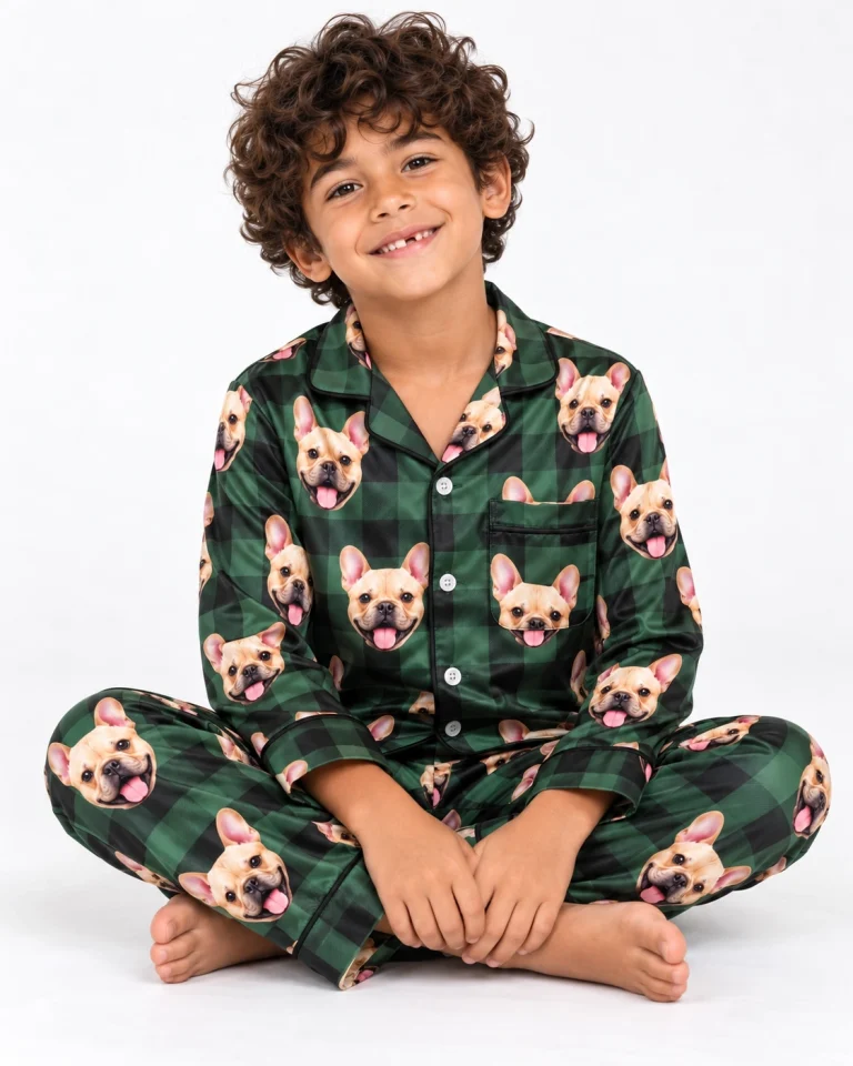 Boy sitting in youth Christmas pajamas covered in fawn French bulldog faces — MyDogPics